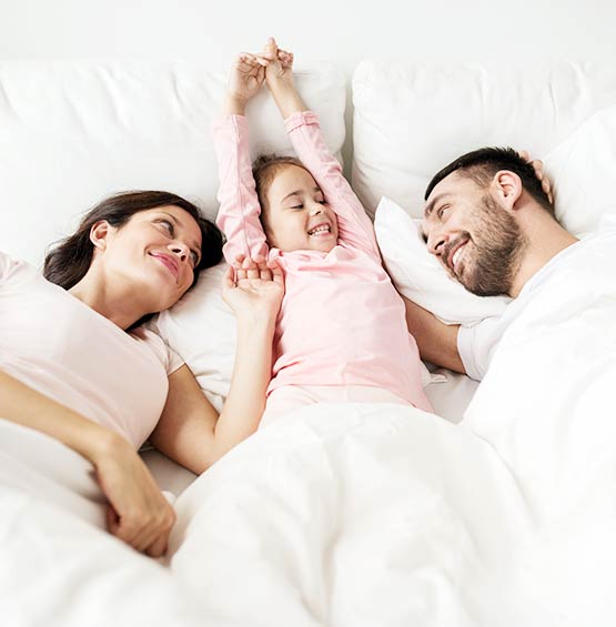 Happy Family laying in bed